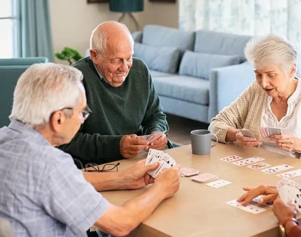 senior-friends-playing-cards-together-at-nursing-h-2021-09-02-08-35-18-utc-copy-e1677692333653
