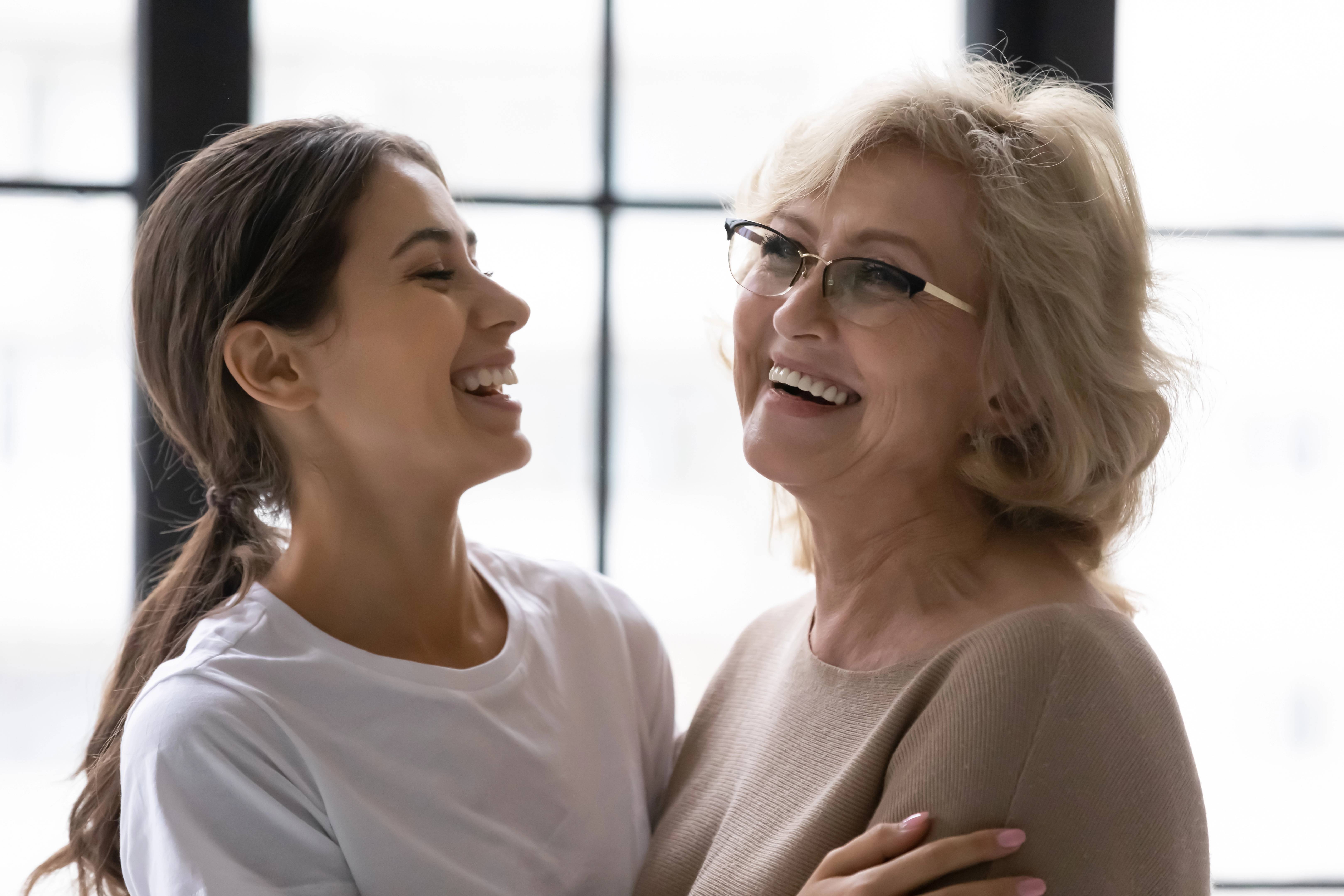 Laughing mature mother and adult daughter